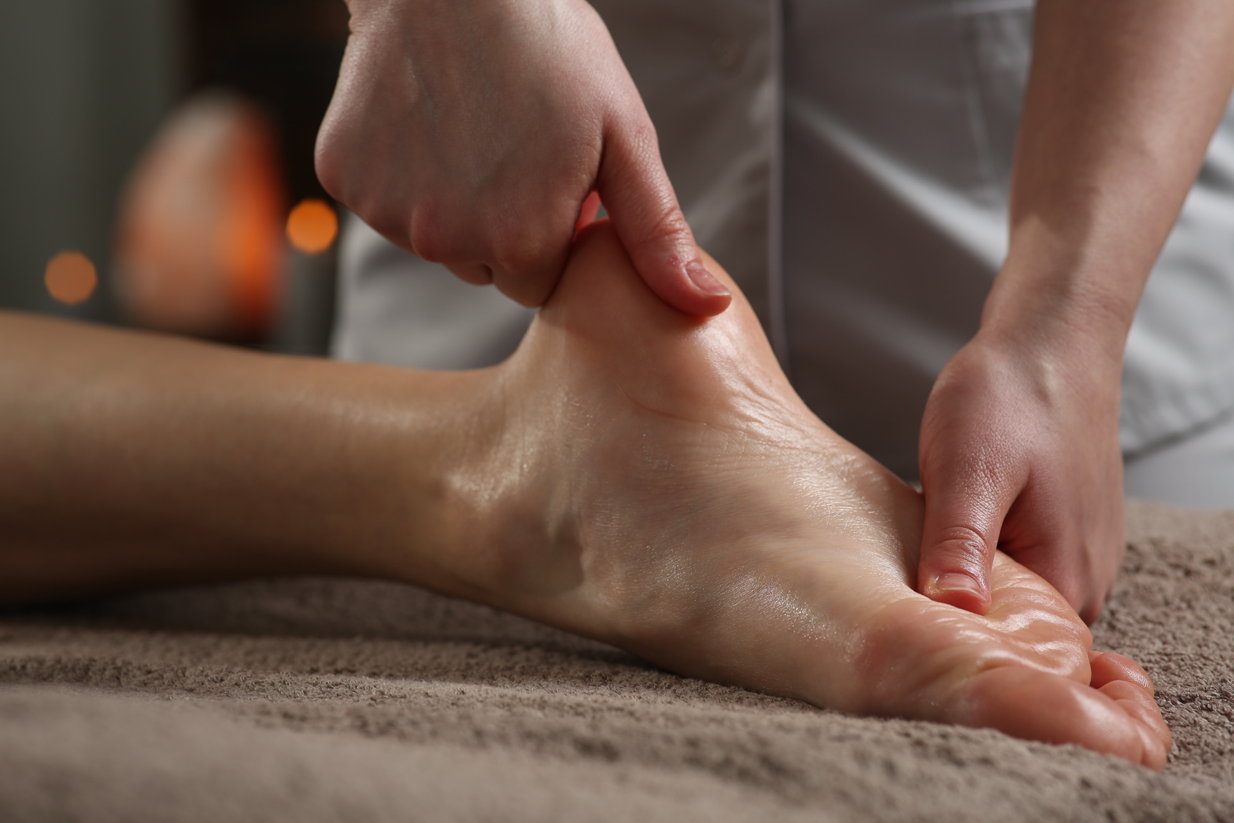 Woman receiving foot massage in spa salon, closeup